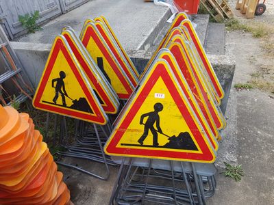 many road signs that are on the side of the road
