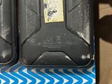 two black suitcases sitting on top of a blue and white box