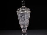 a close up of a glass container on a table with a black background