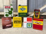 many cans of motor oil sitting on the ground