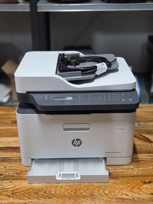 a printer sitting on top of a wooden table in a room