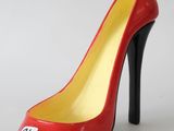 red and yellow high heel shoe with a white tag on the heel