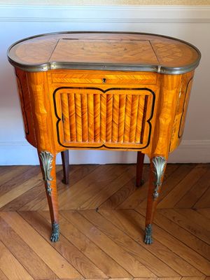 a small table with a wooden top on a hard wood floor
