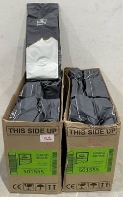 two boxes of clothes sitting on the floor next to each other