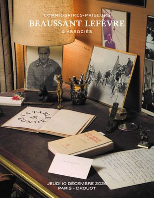 a desk with a lamp, books, and pictures on it