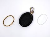 two rings and a ring holder on a white surface
