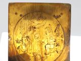 gold plate with a picture of a man and a woman on it