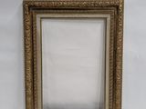 an old picture frame sitting on top of a white surface