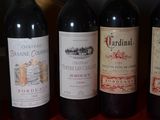 several bottles of wine are lined up in a row on a table