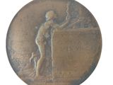 a bronze medal with a woman and a dog on it