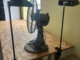 a fan that is sitting on a table in a room