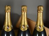 four bottles of champagne are lined up on a table