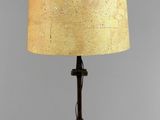 a table lamp with a lamp shade on top of it