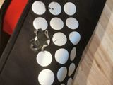 a black and white polka dot tie on a wooden floor