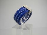 a close up of a blue and white ring on a clear stand