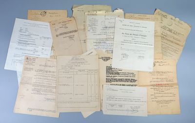 many papers are piled on top of each other on a blue surface