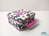 a black and white suitcase with a pink handle