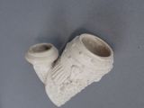 a picture of a white vase and a pipe on a blue surface