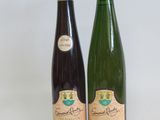 two bottles of wine sitting next to each other on a table