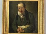 portrait of a man in a green coat with a white scarf