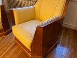 a yellow chair sitting in front of a window in a room