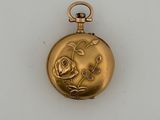 an image of a gold pocket watch with a rose on it