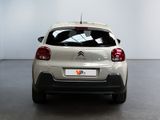 the rear of a white car is parked in a white room