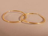 two gold rings sitting on top of each other on a table