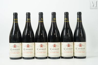 six bottles of wine are lined up on a white surface