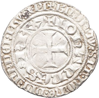 une vieille pièce d'argent ornée d'une croix
