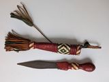 two small wooden knives are sitting on a white surface