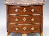 an antique chest of drawers with marble top