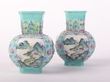 two vases sitting side by side on a white surface