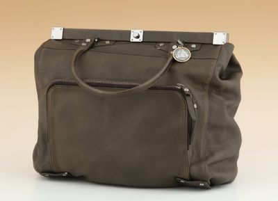 the large brown bag is sitting on a white surface