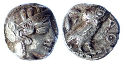 a close up of two silver coins on a white surface
