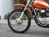 an orange motorcycle parked on the side of the street