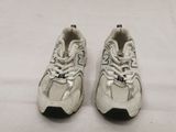 pair of new balance shoes on a white surface with a white background