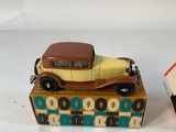 two toy cars that are sitting on top of a box