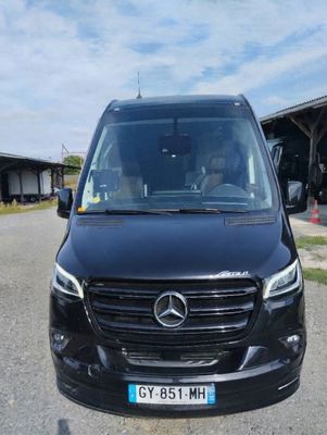 the front view of a black mercedes van parked in a parking lot