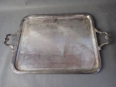 a silver tray with a handle on a table