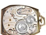 a close up of a pocket watch with a white background