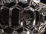 a glass vase with a design on it on a black background