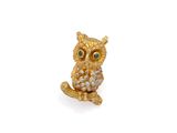 an image of a gold owl broochle with green eyes