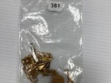 a small bag with some gold items inside of it