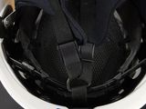 a close up of a helmet on a table with a tag attached to it