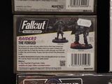 two boxes of fallout miniatures on display in a store