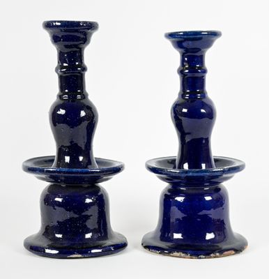 two blue vases that are sitting on a table