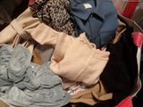 a suitcase full of clothes and clothes sitting on the floor