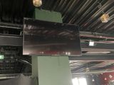 a television hanging from the ceiling in a building