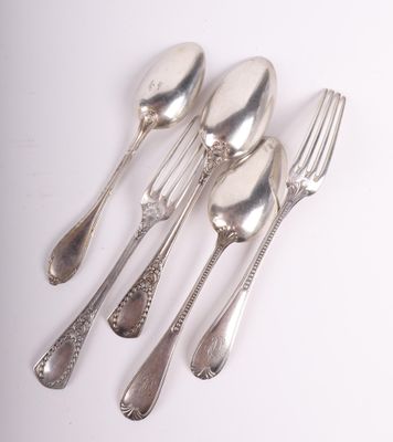 four silver spoons and a fork on a white surface